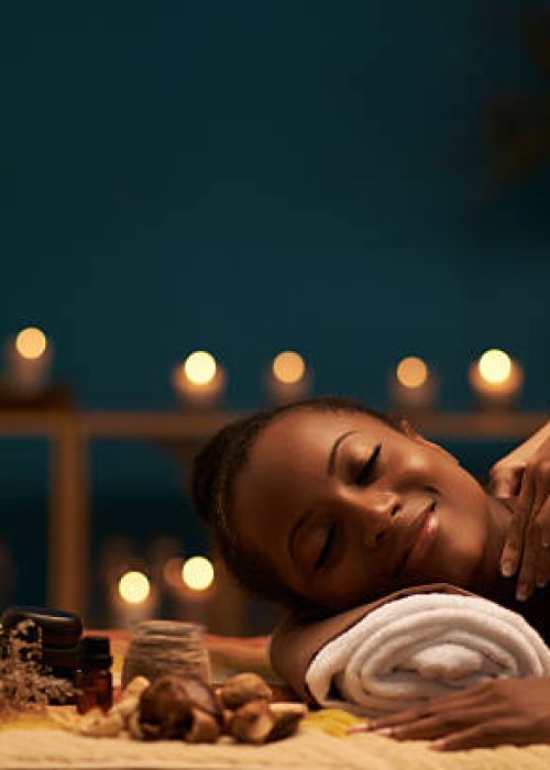 Happy young woman receiving relaxing back massage